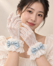Model wearing sheer white lace gloves with ice blue Christmas Bridal bow cuffs