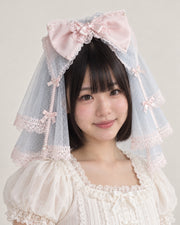 Cherry Blossom Confession pink bow and blue short veil — model view