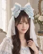 Model wearing ice blue Christmas Bridal Lolita KC headband with white veil